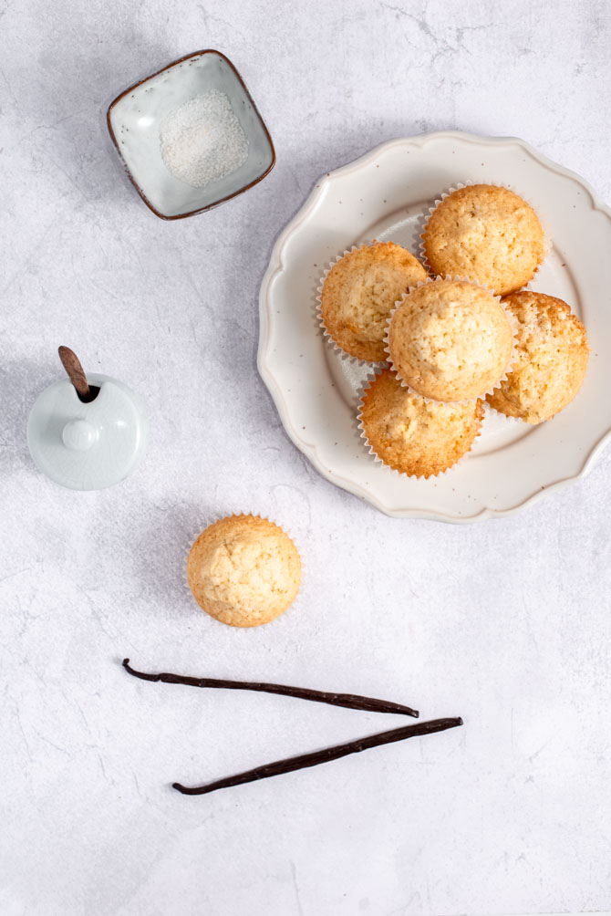 Delicious vanilla cupcakes on a plate with a vanilla pod