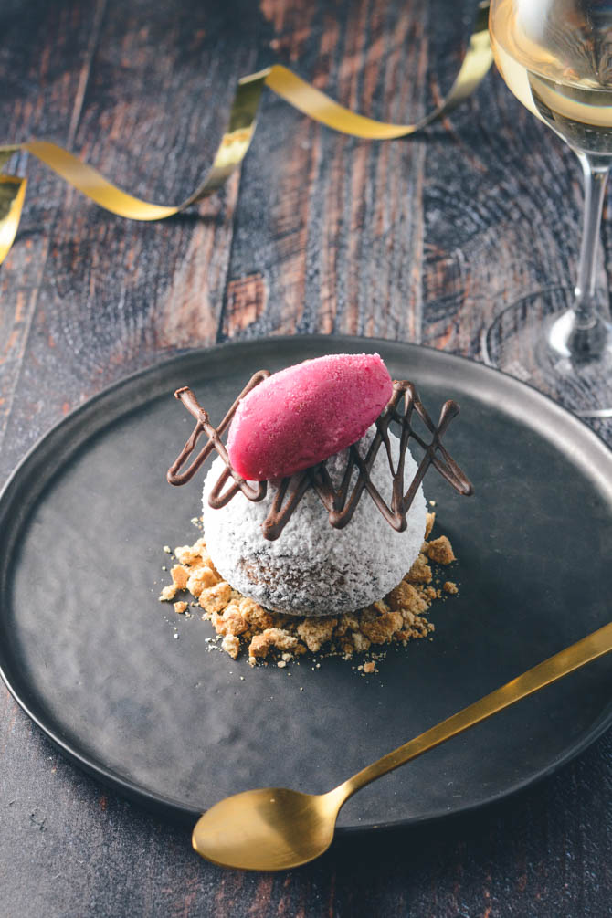 Plated dessert with snowball chocolate mousse cake