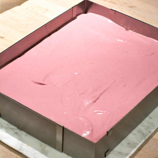 Bowl of blackberry mousse for number cake filling