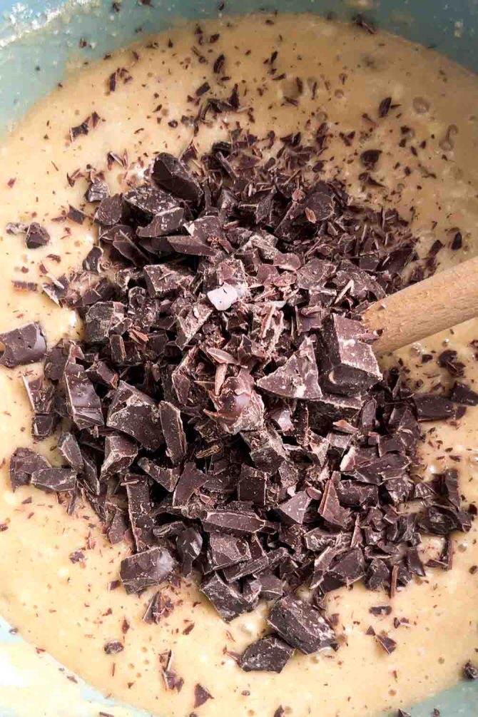 Chocolate chips being added to banana cake batter