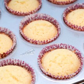 Baked lemon cupcakes cooling before frosting