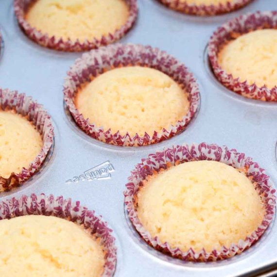Baked lemon cupcakes cooling before frosting