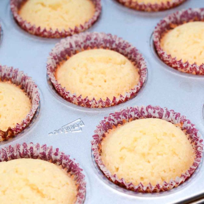 Baked lemon cupcakes cooling before frosting