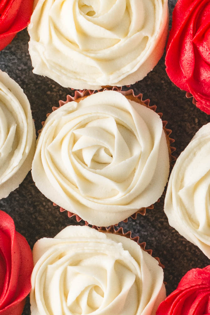 Cupcakes topped with vanilla buttercream and small flag picks