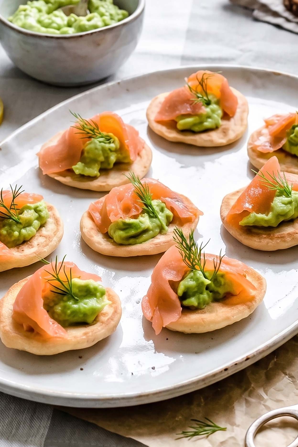 Blinis with salmon and avocado cream on a plate