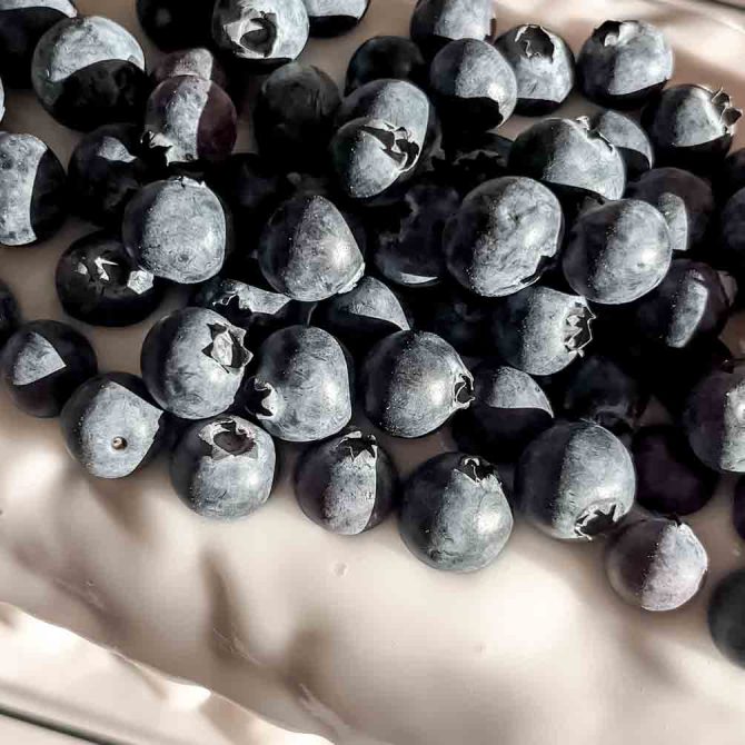 Sliced lemon blueberry loaf cake on a cutting board
