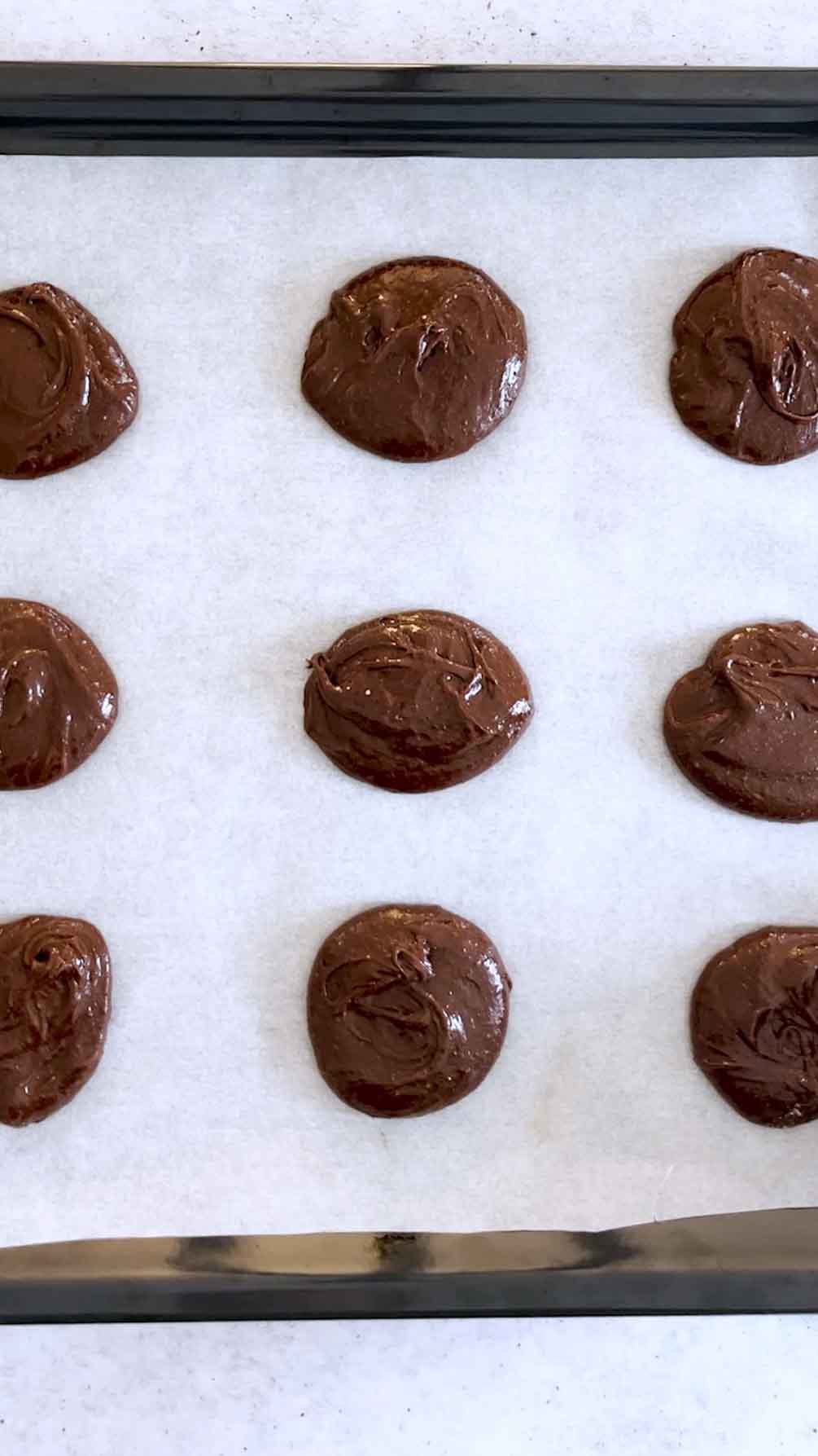 Brownie cookies arranged on a baking sheet