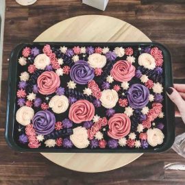 Colorful buttercream frosting spread on chocolate sheet cake