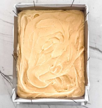 Cake batter spread in a pan for number cake layers