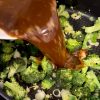 Cashew chicken sauce simmering with chicken pieces