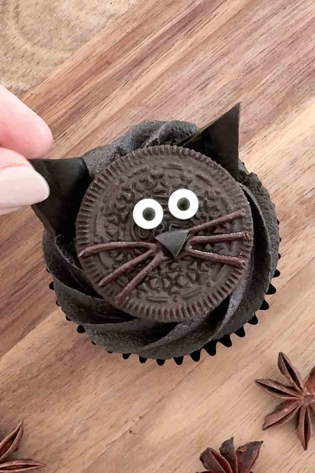 Cupcakes topped with black cat ears