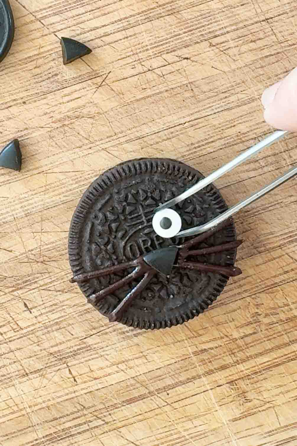 Oreo cookie halves used as cat ears on a cupcake