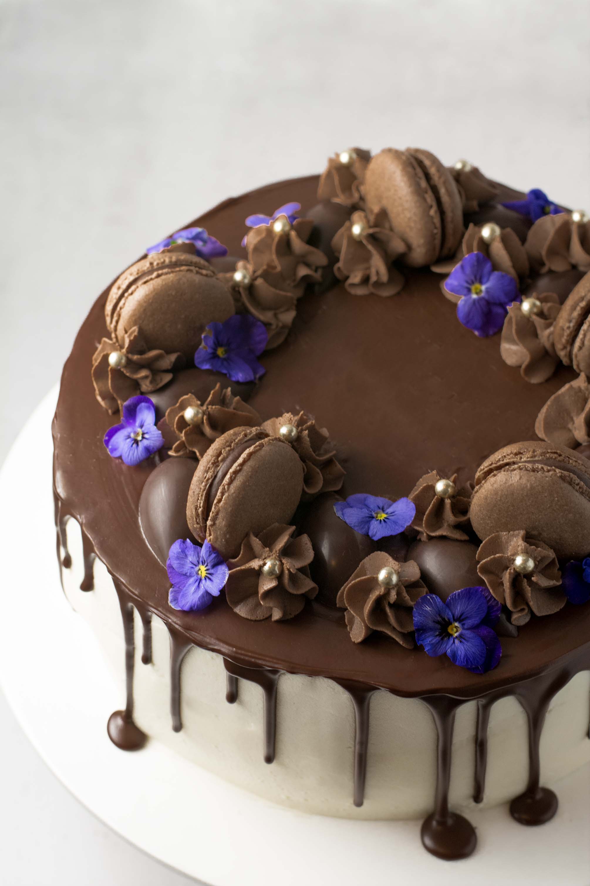 Chocolate layer cake topped with macarons