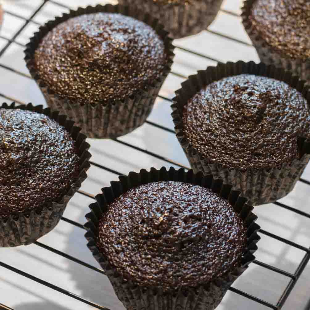Chocolate cupcakes cooling on a wire rack