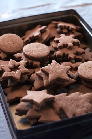 Chocolate sugar cookies cut into Christmas shapes