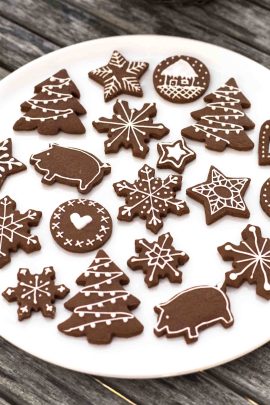 Chocolate cookie dough cut with Christmas cookie cutters