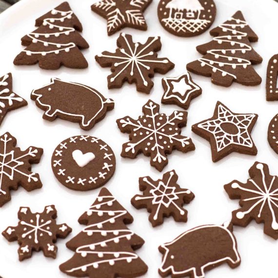 Chocolate cookie dough cut with Christmas cookie cutters