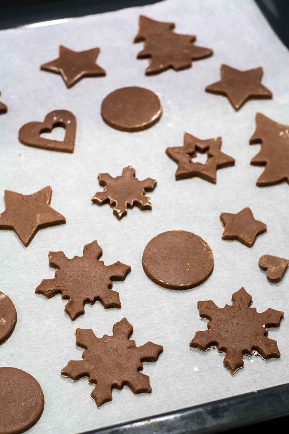 Christmas shaped cookie cutter pressed into chocolate dough