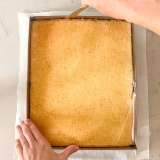 Cake layer being cut freehand into a number shape