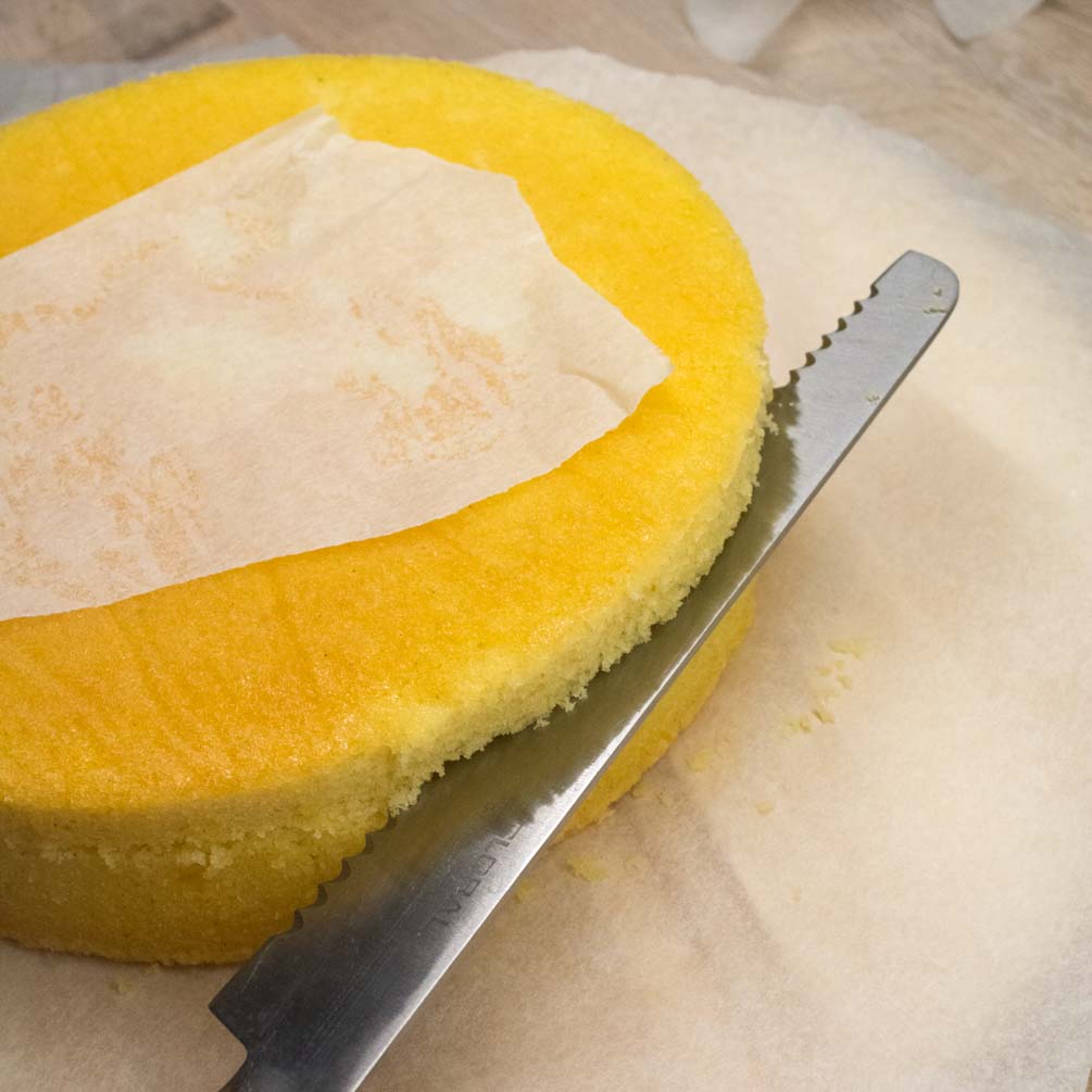 Slicing a chocolate cake sponge into layers