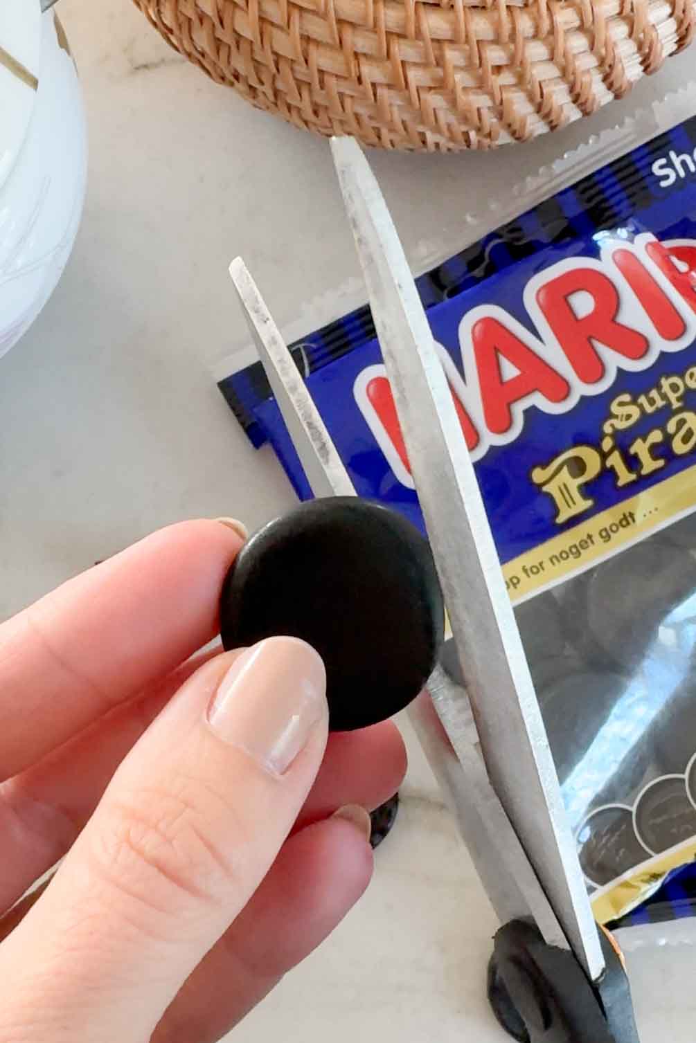 Cutting licorice strips for black cat cupcake whiskers