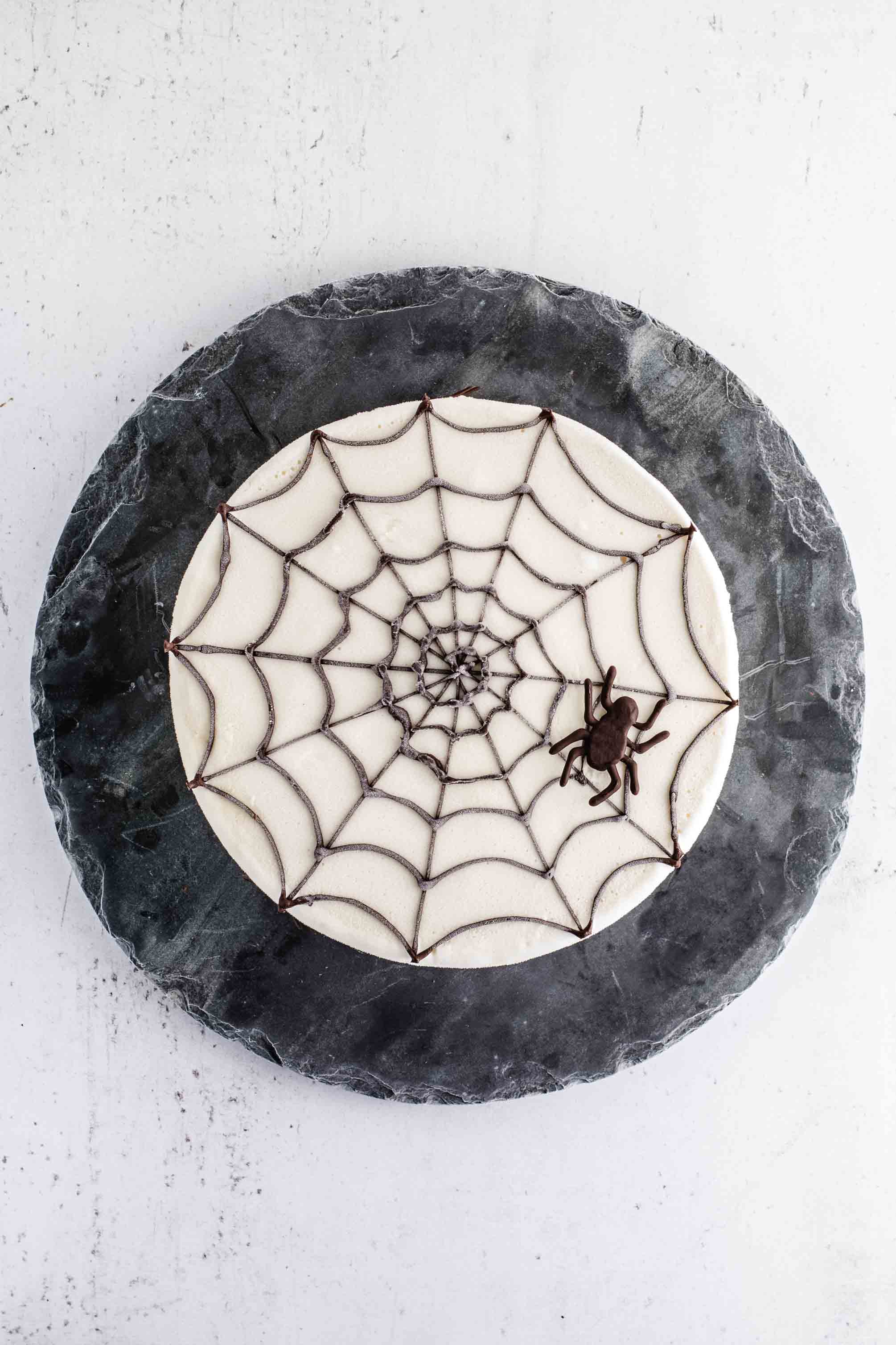 Ice cream cake decorated with a spider web design for Halloween