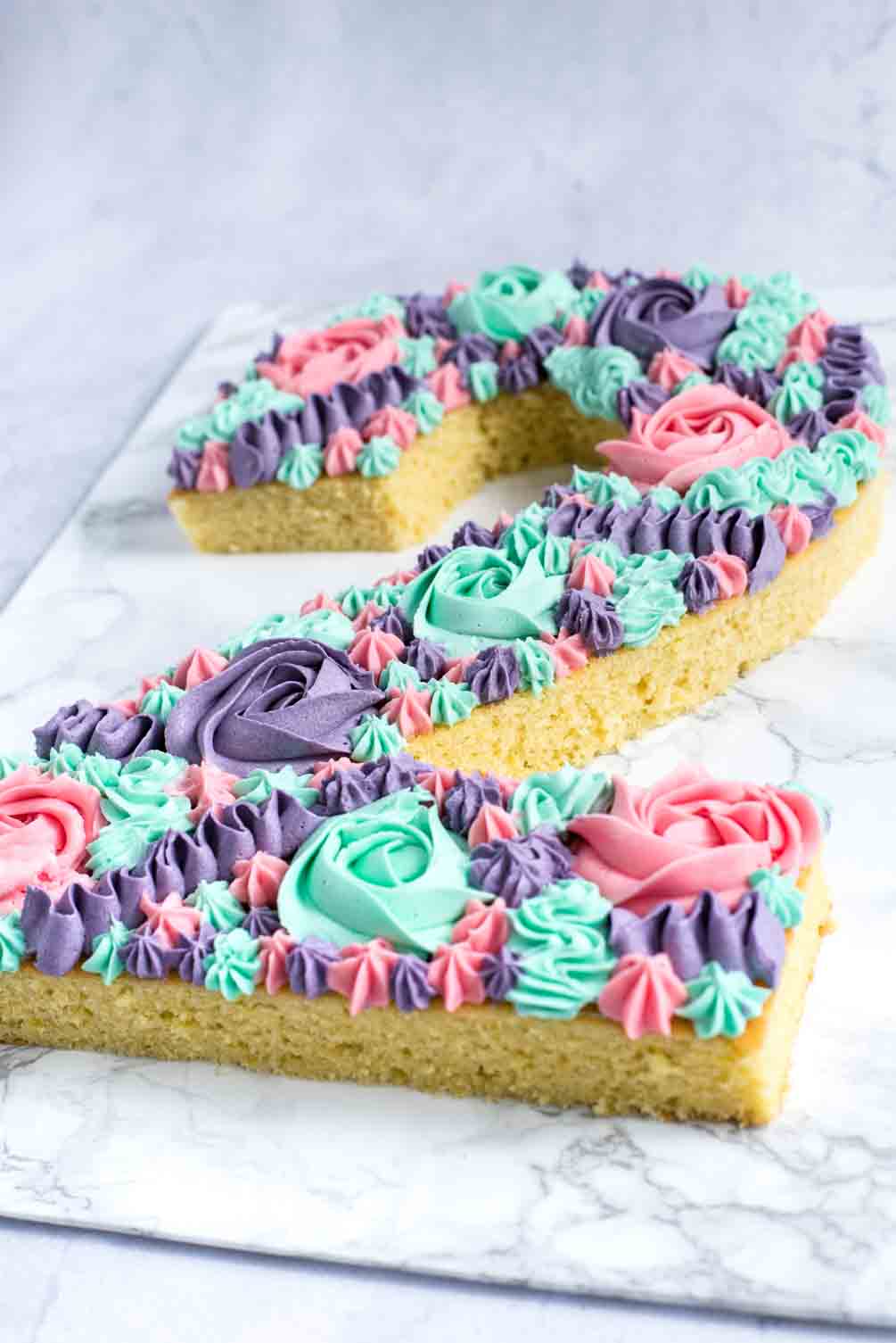 Frosting spread over layers of a vanilla lemon cake