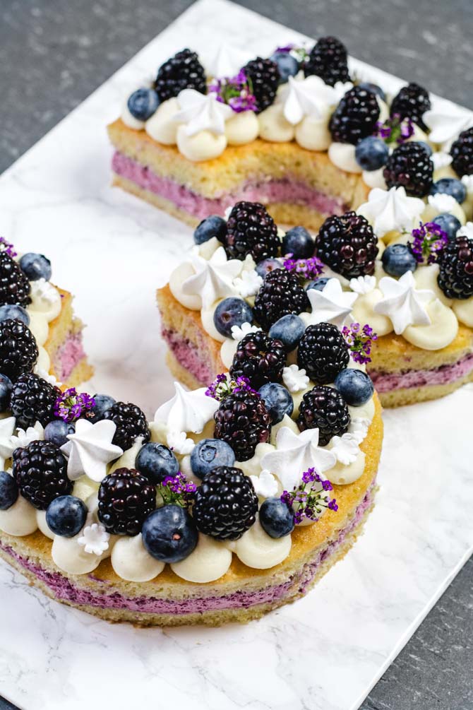 Number cake decorated with flowers and blackberries