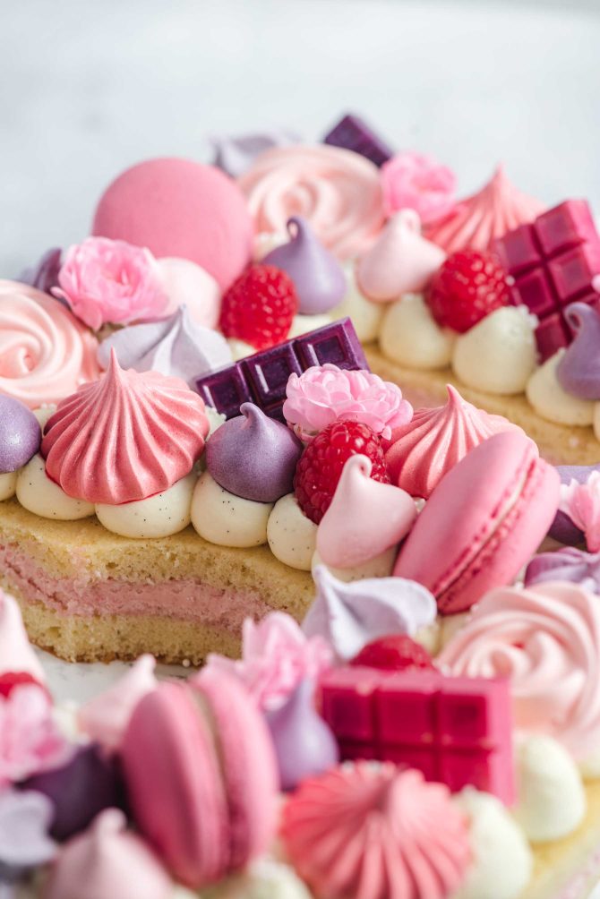 Meringue kisses decorating a raspberry number cake