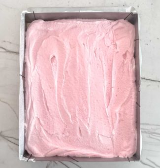 Bowl of raspberry mousse for number cake filling