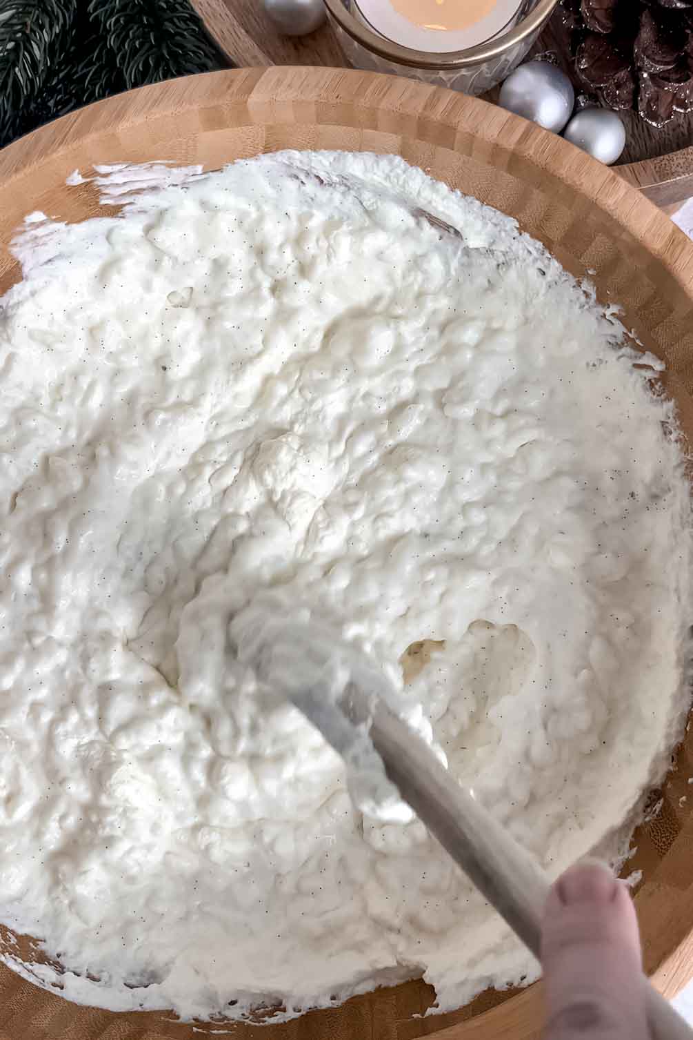 Stirring risalamande pudding in a mixing bowl