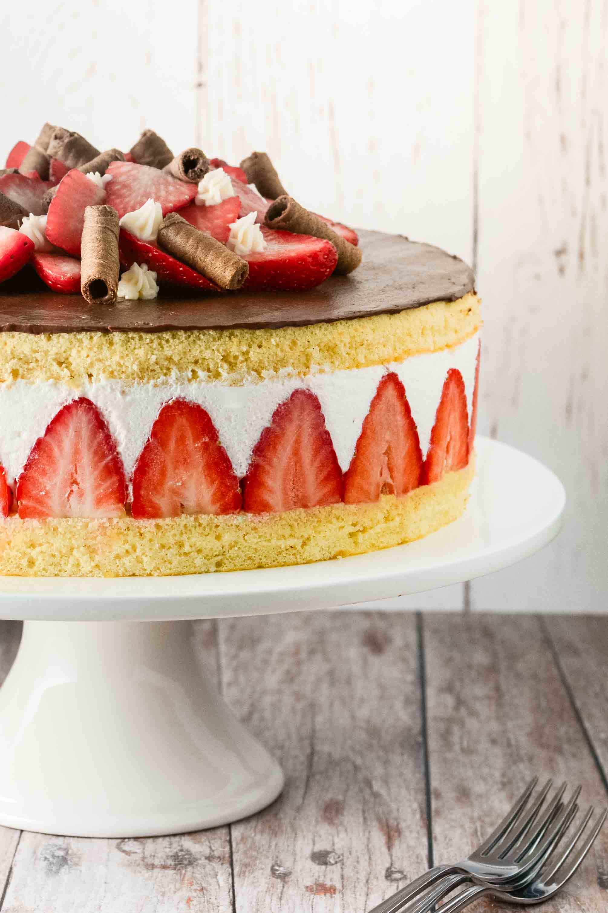 Slice of strawberry layer cake with elderflower cream