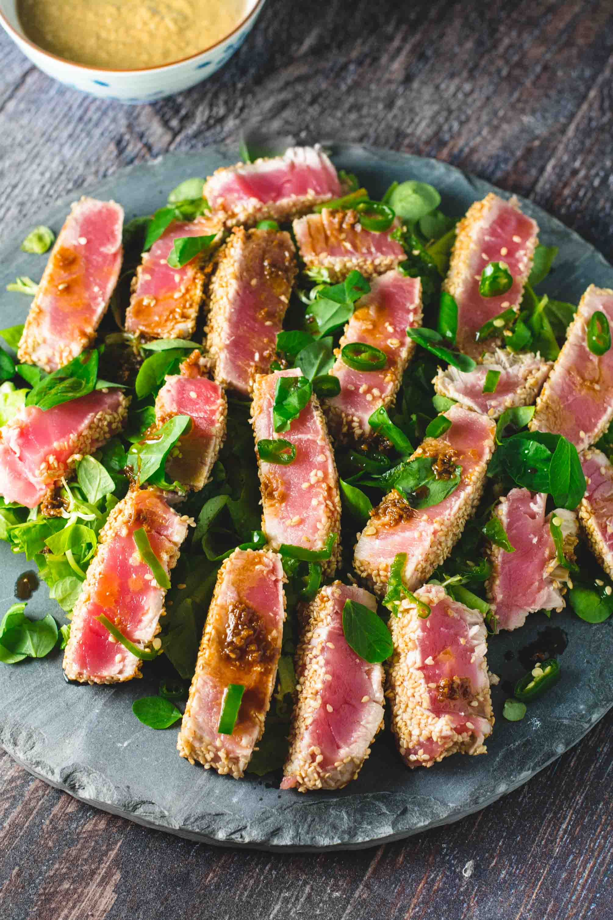 Seared tuna slices served over a salad