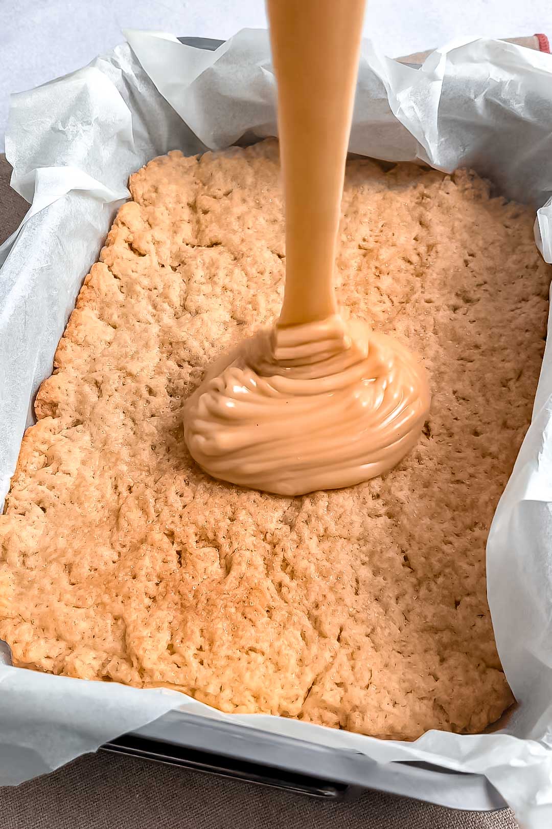 Caramel layer spread over shortbread cookie base