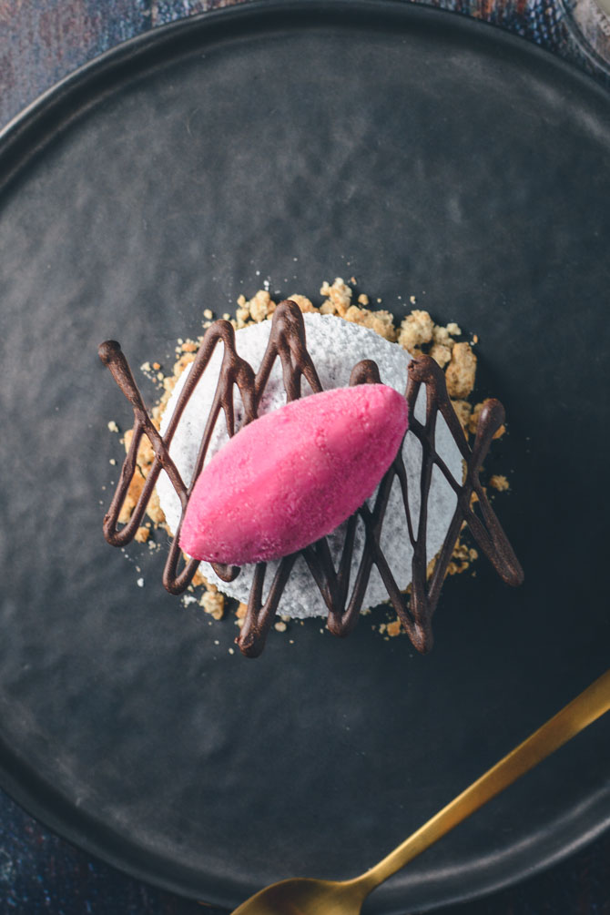 Pomegranate sorbet on chocolate cake, a plated dessert